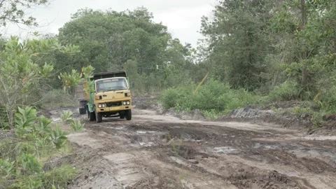 Muddy road of sand mining site with dumper tucks Stock Footage 160304017