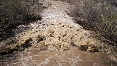 Muddy runoff water splashes violently-Slow motion Stock Footage 240503337