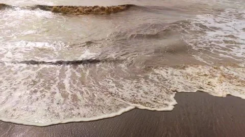 Muddy Sea Waves Washing Onto Sandy Shore with White Foam Stock Footage 345308165