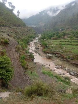 Muddy Swat River Flowing Through Green Hills After Monsoon Stock Photos