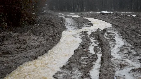 Muddy water flow down the dirt road like stream Stock Footage 240642472