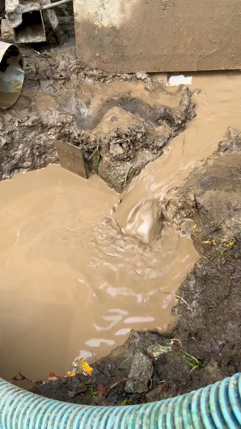 Muddy water flowing into a construction pit during excavation work at a building Stock Footage 336143803