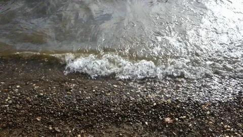 Muddy water waves on the coast Stock Footage 125442926