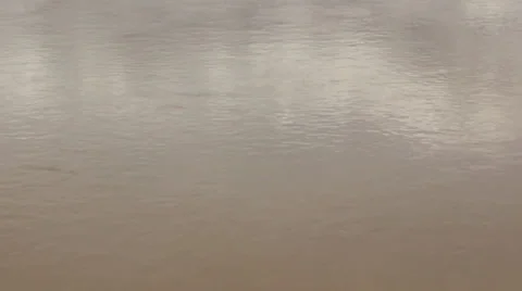 Muddy water waving. White reflection on river surface. Flood river. Background. Vídeos de archivo 38939460