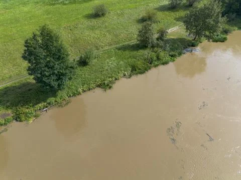 Mudflow of water in the Oder River of brown color. Poland. View from above... Stock Photos