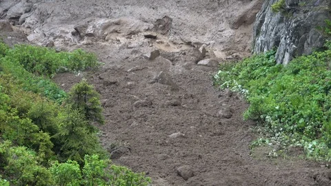 Muds of landslide flows down the valley Stock Footage 123853964