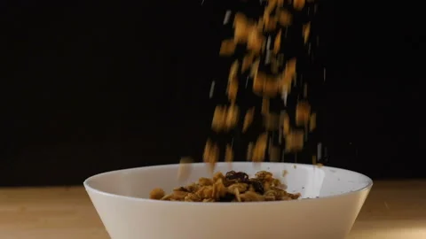 Muesli falling into a bowl Stock Footage 126708319