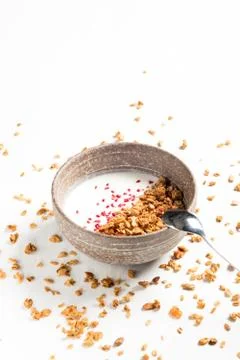 Muesli with milk in bowl on white table Stock Photos