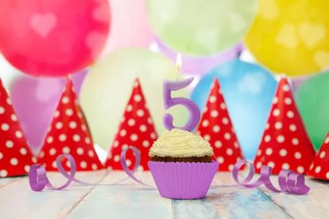 Muffin with candle in number 5 shape Stock Photos