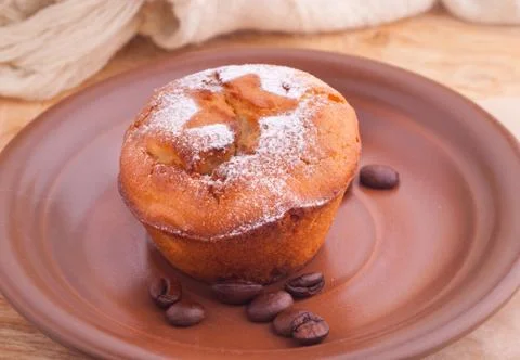 Muffin with icing sugar star and coffee beans Stock Photos