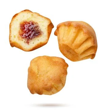 Muffins and half with jam flying close-up on a white. Isolated Stock Photos