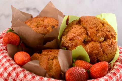 Muffins and strawberries Stock Photos