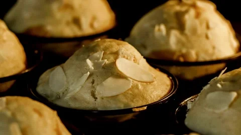 Muffins baking and rising in muffin tin in electric oven at home close up, zoom Stock-Footage 336576606