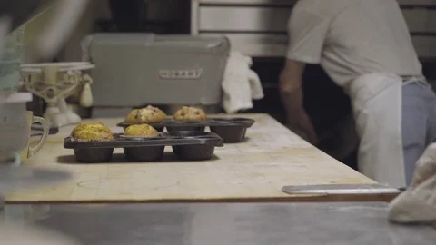 Muffins being pulled out of oven to cool Stock Footage 73899075