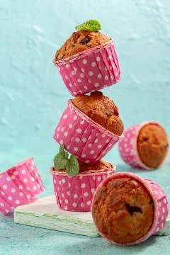 Muffins with currant in pink forms. Stock Photos