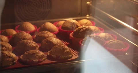 Muffins increasing in size baking in the oven Stock Footage 271023535