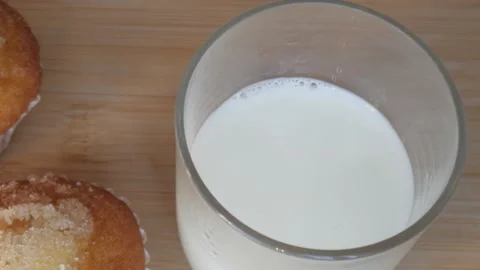 Muffins with Milk - Cozy Breakfast Setting on Wooden Table Stock Footage 334581148