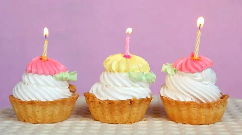 Muffins or cakes with burning candles on pink background 動画素材 67404553