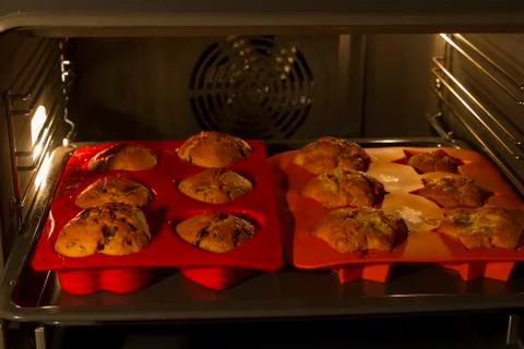 Muffins in oven Stock Photos
