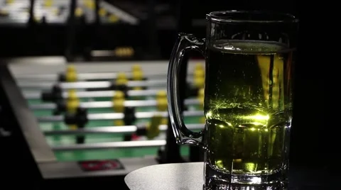 Mug of beer and a Foosball Table at a sports bar Stock Footage 45623196
