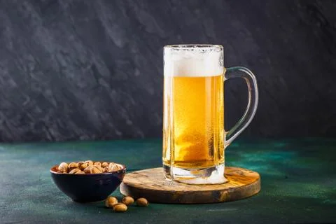 Mug of beer on dark background Stock Photos