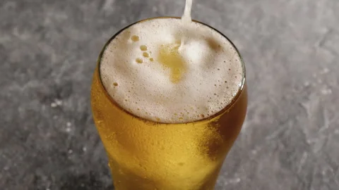 Mug of beer on gray background Stock Footage 243596457