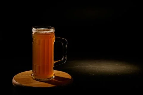 Мug of beer isolated with light in the background.Space for text Stock Photos