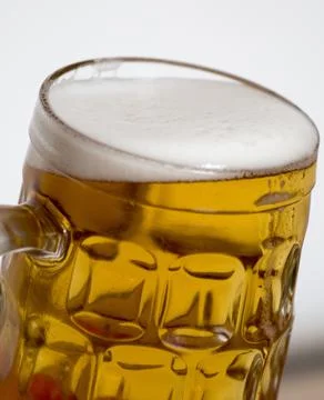 A mug of beer overflowing Foto stock