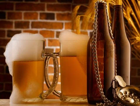 Mug of beer poured in rustic setting Stock Photos