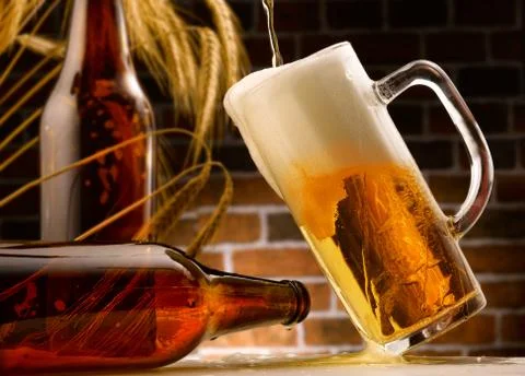 Mug of beer poured in rustic setting Stock Photos