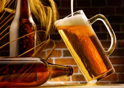 Mug of beer poured in rustic setting Stock Photos