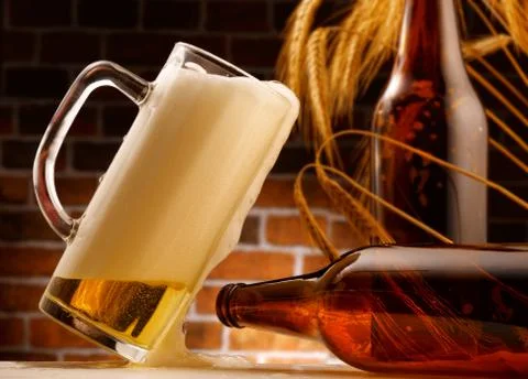 Mug of beer poured in rustic setting Stock Photos