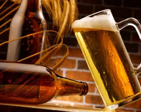 Mug of beer poured in rustic setting Stock Photos
