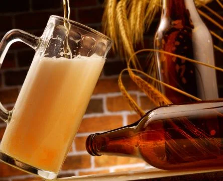 Mug of beer poured in rustic setting Stock Photos