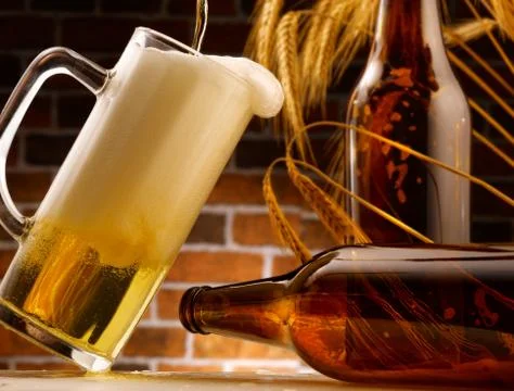 Mug of beer poured in rustic setting Stock Photos