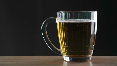 Mug of beer standing on black background Stock-Footage 144598291