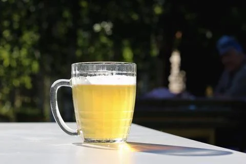 Mug of beer on the table on nature background Stock Photos