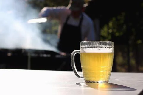 Mug of beer on the table on nature background Stock Photos