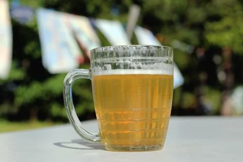 Mug of beer on the table on nature background Stock Photos
