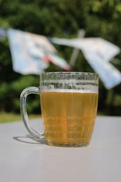 Mug of beer on the table on nature background Stock Photos