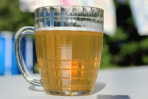 Mug of beer on the table on nature background Stock Photos