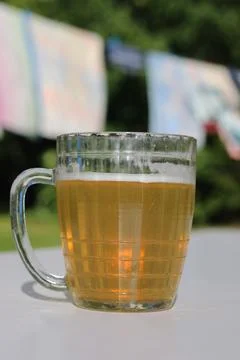 Mug of beer on the table on nature background Stock Photos