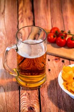 Mug with beer on the table with snack Stock Photos