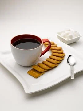 Mug of black tea in serving plate with sugar cubes and biscuits India Foto stock