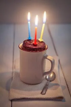 Mug cake with candle Stock-Fotos
