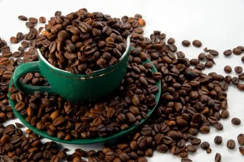Mug with coffee beans Stock Photos
