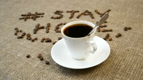 Mug of coffee, coffee beans, and words stay home, coronavirus concept, self h Video stock 128756690
