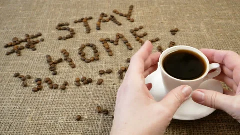 Mug of coffee, coffee beans, and words stay home, coronavirus concept, self h Video stock 128756779