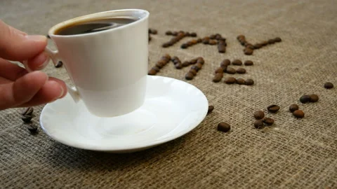 Mug of coffee, coffee beans, and words stay home, coronavirus concept, self h Video stock 128756849