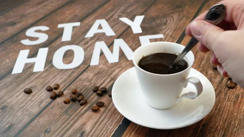Mug of coffee, coffee beans, and words stay home, coronavirus concept, self h Video stock 128758087